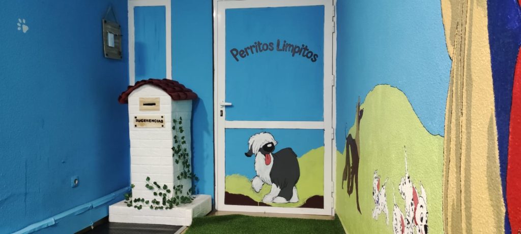 Photocall con el buzón de sugerencias de Perritos Limpitos en Ciudad Real, donde los clientes dejan sus ideas y posan con sus mascotas.